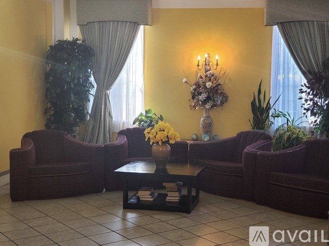 A living room with a large sofa, armchair, and coffee table.