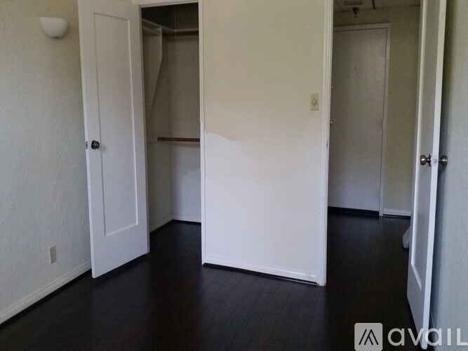 A room with white walls and a wooden floor.