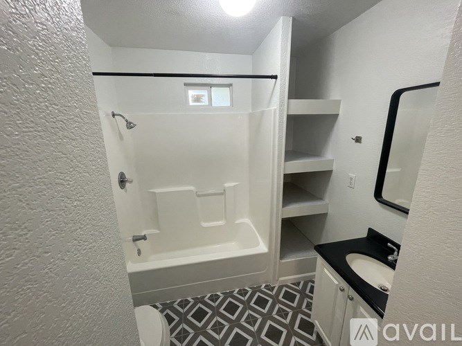 A bathroom with a toilet, sink, and a shower with a glass door.
