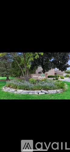 A tree in a landscaped yard with a sign that says "smart guage".