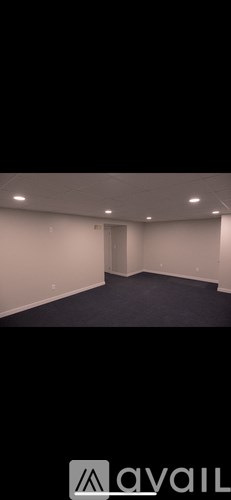 A room with a carpeted floor and a door.