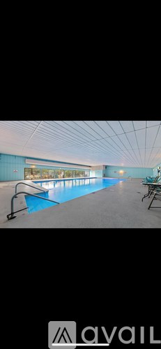 A large indoor swimming pool with lane dividers.