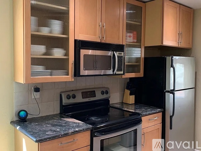 A kitchen with a black oven, black microwave, and black refrigerator.
