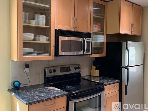 A kitchen with a black oven, black microwave, and black refrigerator.