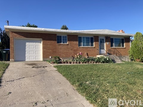 A red brick house with a white garage door.