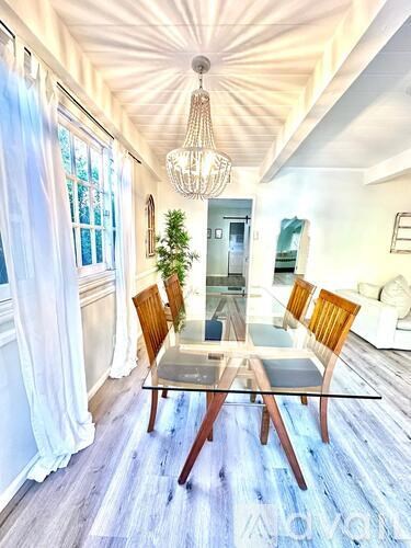 A dining room with a glass table and chairs.