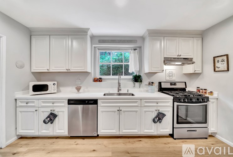 A kitchen with white cabinets and stainless steel appliances.