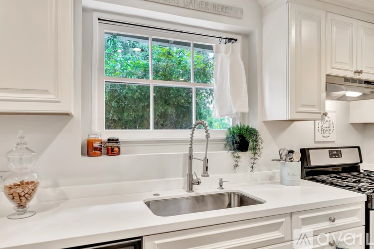 A kitchen with a sink and a window.