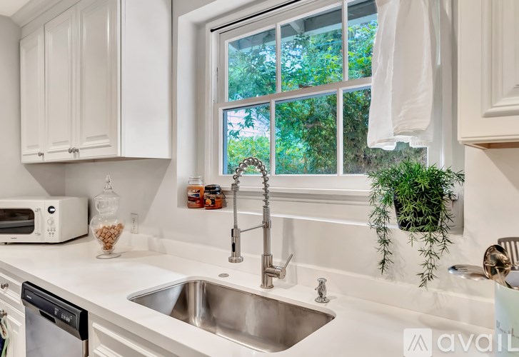 A kitchen with a white countertop and a window.