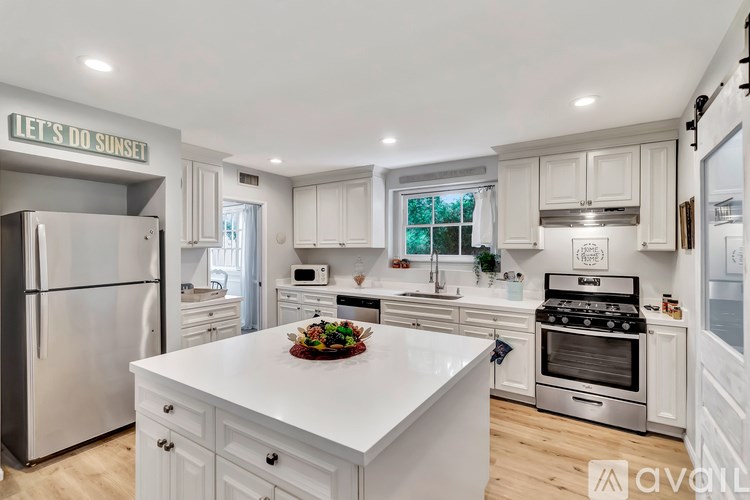 A kitchen with a white countertop and stainless steel appliances.
