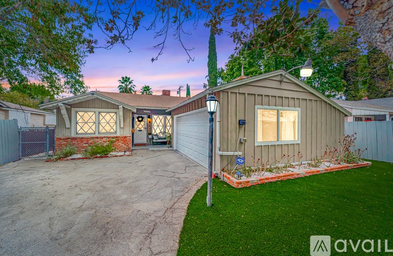 A house with a garage and a driveway is available for sale.