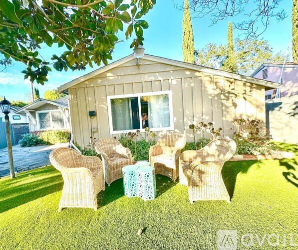 A house with a patio and chairs.