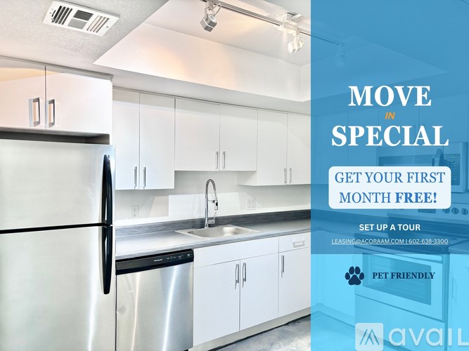 A modern kitchen with a refrigerator, sink, and cabinets is advertised for a free first month.