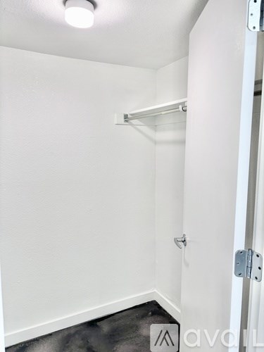 A white door with a silver handle and a silver lock.