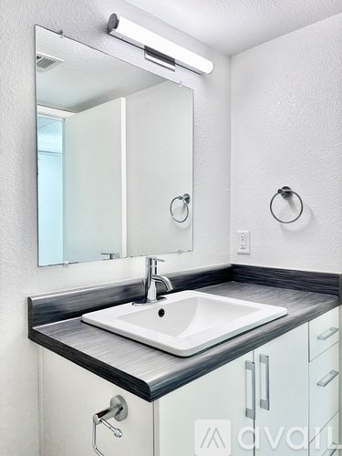A bathroom sink with a mirror above it.