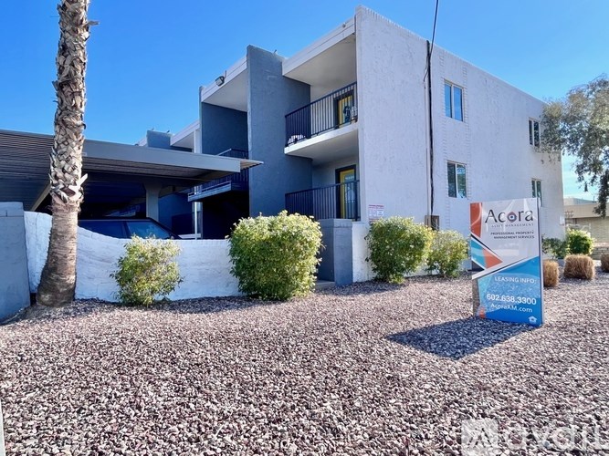 A modern building with a sign in front that says Acora.