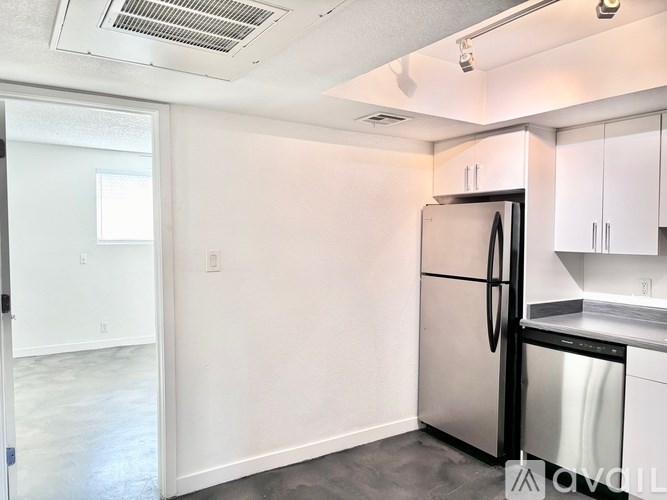 A kitchen with a stainless steel refrigerator and dishwasher.