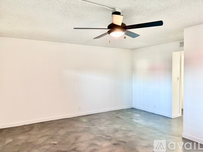 A room with a ceiling fan and a light fixture.