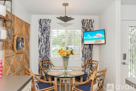 A dining room with a glass table and chairs.