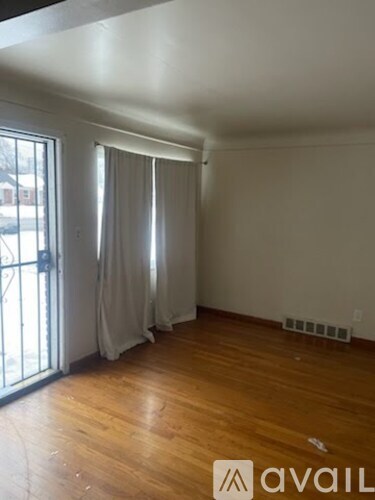 A room with wooden floors and a sliding door.