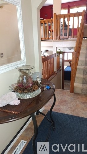 A table with a vase and a blue object on it.