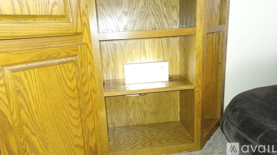 A wooden cabinet with a drawer partially open.