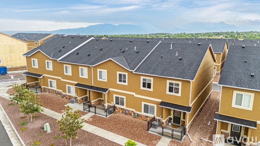 A row of houses with a mountain in the background.