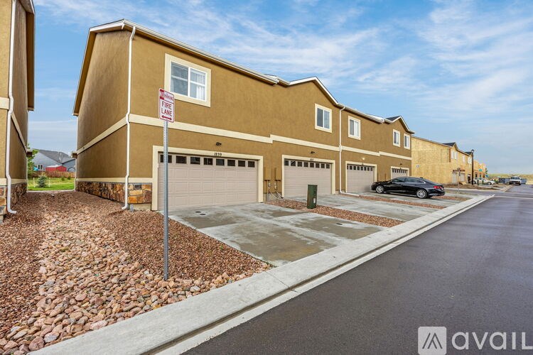 A row of houses with a "No Parking" sign in front of the first one.
