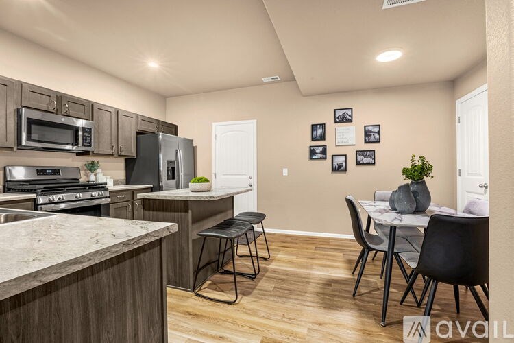 A kitchen with a table and chairs in the middle of the room.