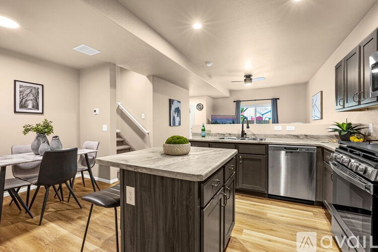 A kitchen with a dining table and chairs is available for rent.