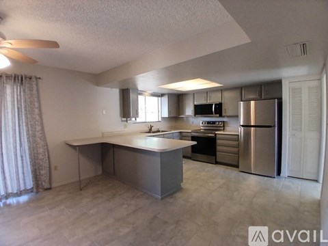 A kitchen with a stainless steel refrigerator and microwave.