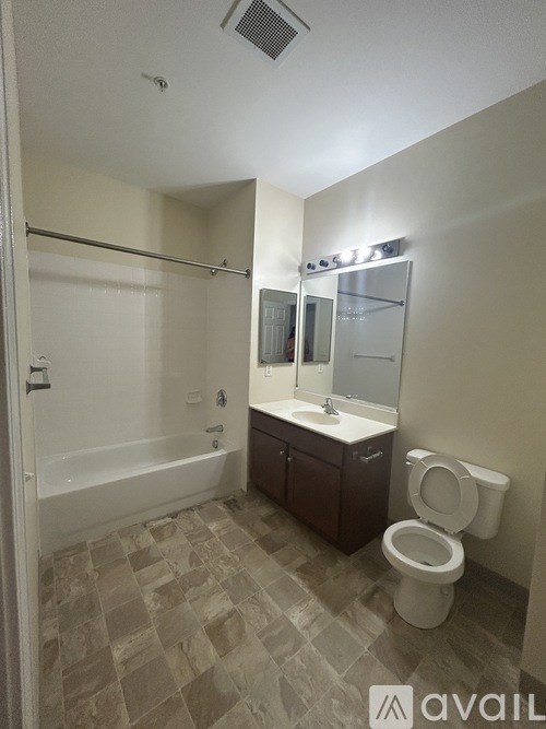 A bathroom with a toilet, sink, and bathtub.
