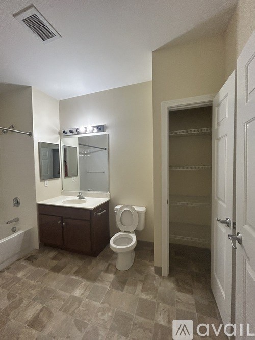 A bathroom with a toilet, sink, and shower.