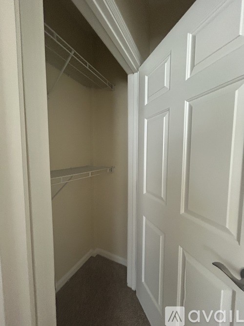 A white door with a handle and a small window above it.