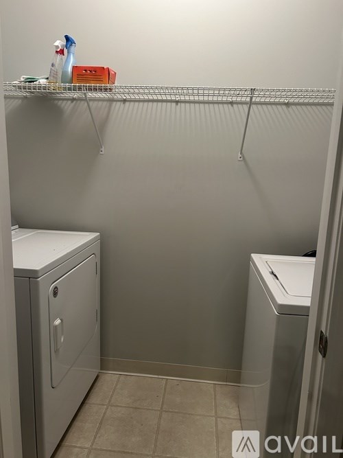 A small bathroom with a toilet and a cabinet.