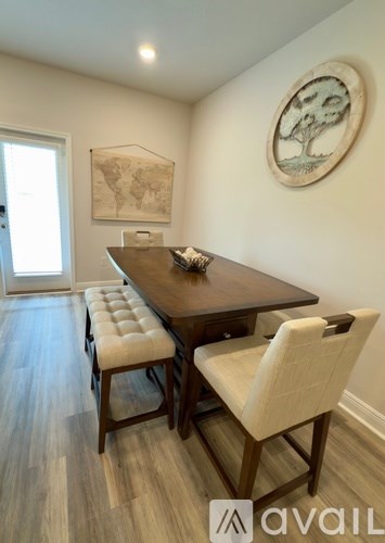 A dining room with a wooden table and chairs.