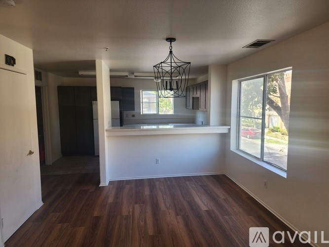 A room with wooden floors and a large window.