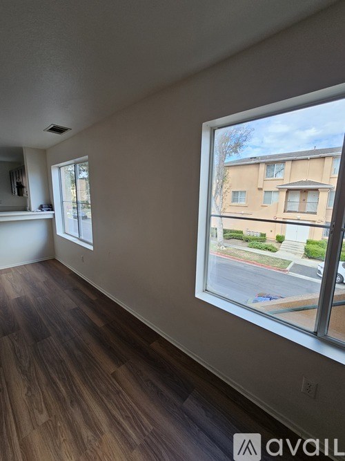 A room with a large window overlooking a street.