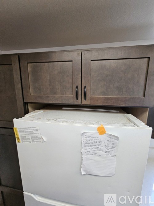 A white box with a piece of paper taped to it.