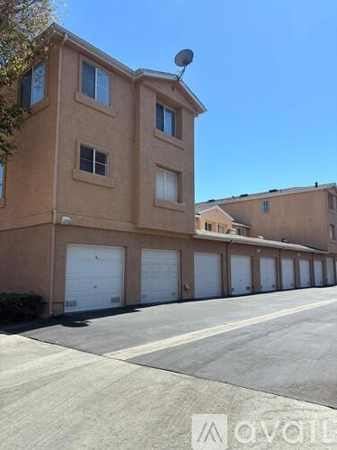 A building with a brown facade and a row of garage doors.