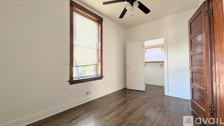 A room with a window and a ceiling fan.