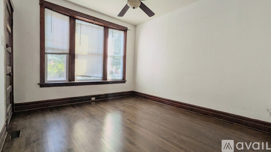 A room with a window and a ceiling fan.