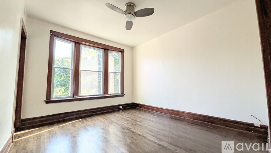 A room with a ceiling fan and a window.