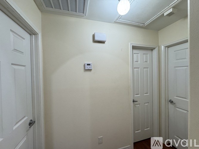 A white door is on the left and a white door with a window is on the right.