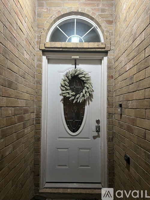 A white door with a wreath on it.