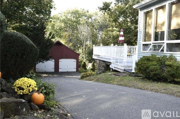 A house with a red and white striped object in the yard.