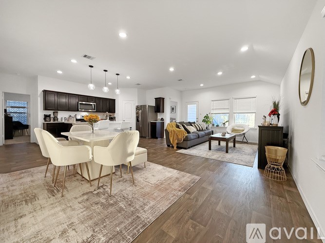 A modern living room with a dining table and chairs.
