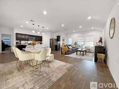 A modern living room with a dining table and chairs.