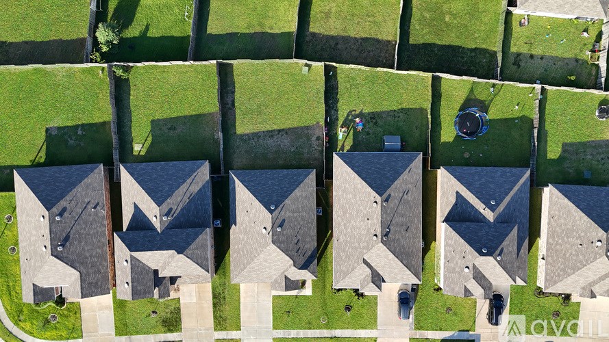 A row of houses with a grassy lawn in front.