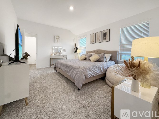 A bedroom with a bed, a nightstand, and a dresser.